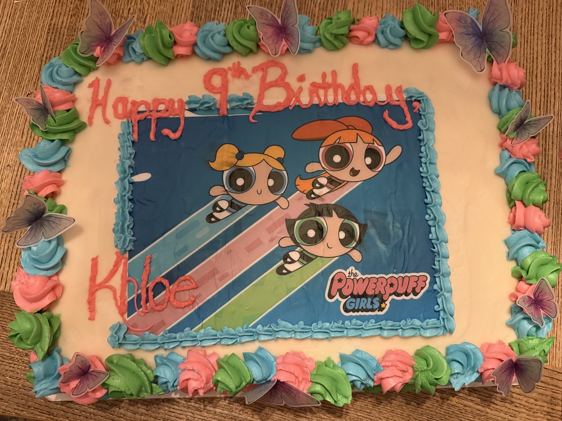 Themed birthday sheet cake with colorful piped border