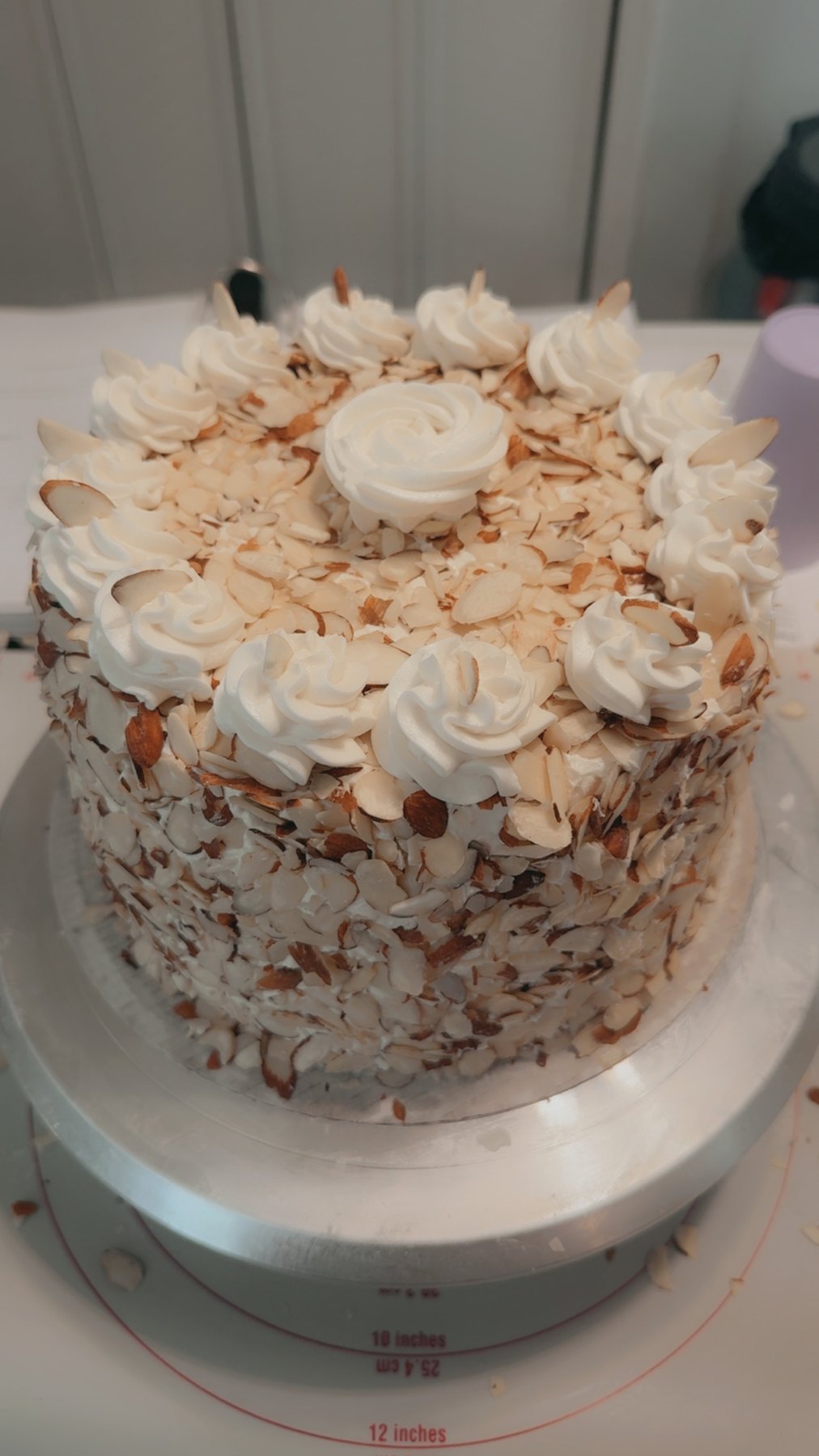 Coconut layer cake with piped cream rosettes
