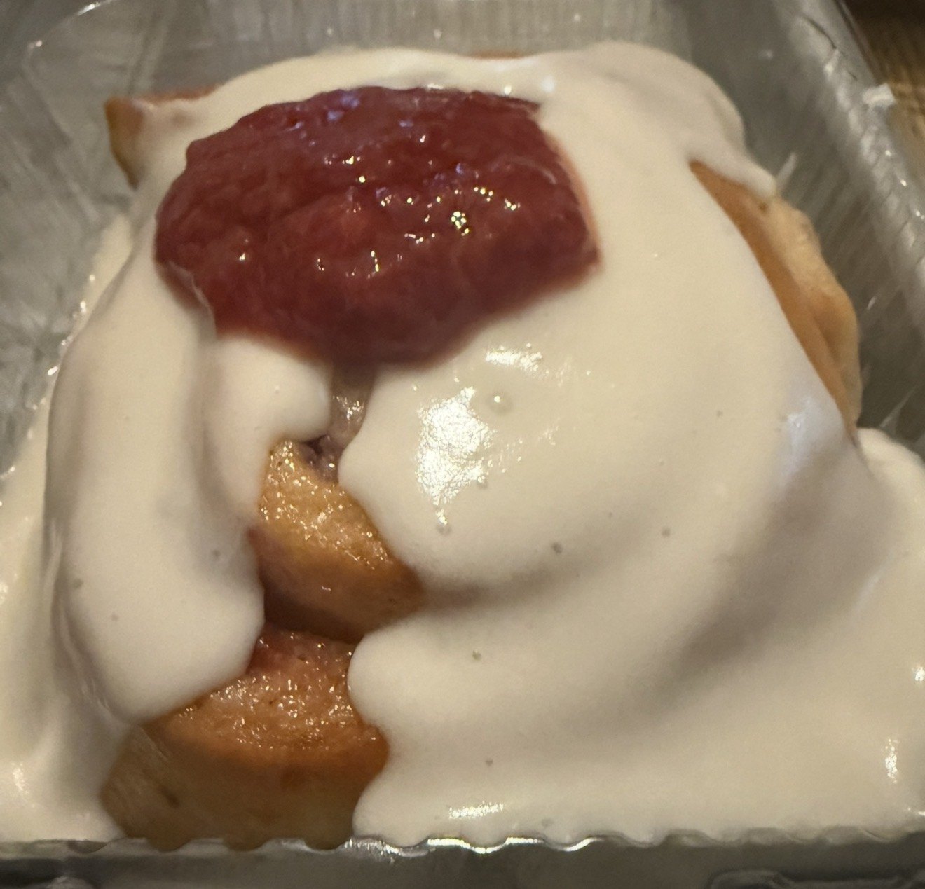Strawberry-topped cinnamon roll with icing